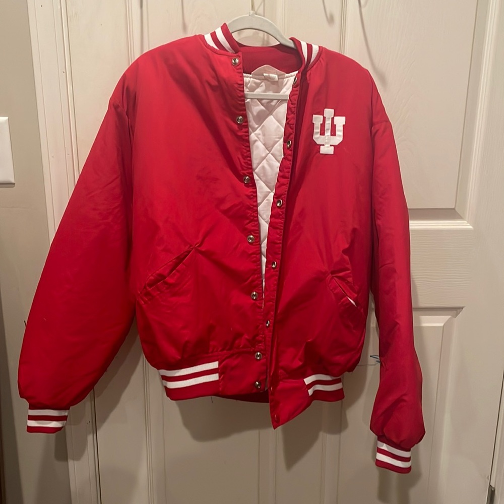 a red and white Indians coat with strips on the bottom of the coat and sleeves